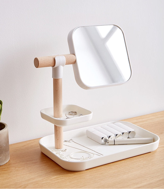Cosmetics Storage Box with Mirror on a stylish counter with jewelry and beauty products organized.