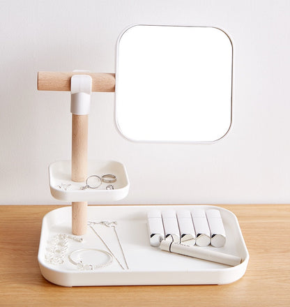 Cosmetics Storage Box with Mirror on a stylish counter with jewelry and beauty products organized.