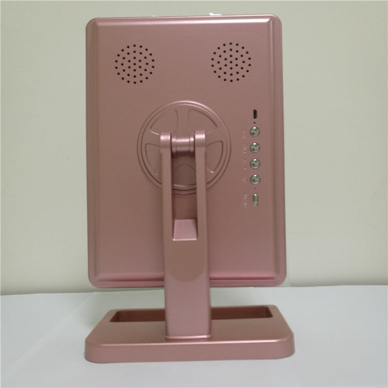 Touch screen makeup mirror with speaker featuring LED lights and a side magnifying mirror in stylish pink design.
