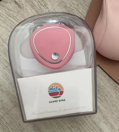 Microcurrent beauty massager in pink with charging cable and clear case for skincare enhancement.