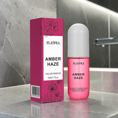 Fragrance spray and body perfume Amber Haze with floral packaging on a modern bathroom counter.
